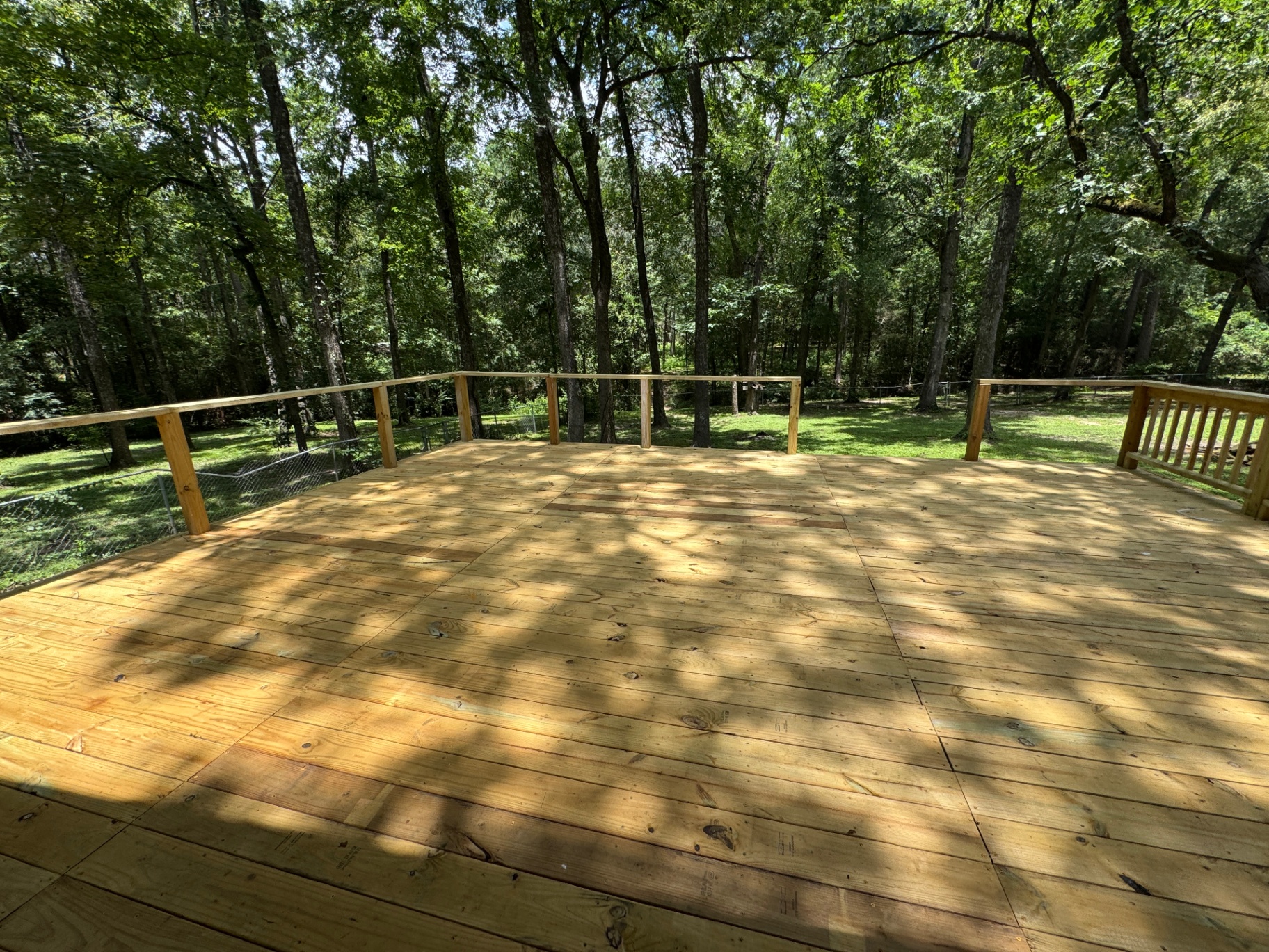 Finished cabin deck overlooking the forest