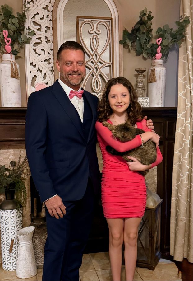 Dr. Pelton and daughter at formal event with their cat