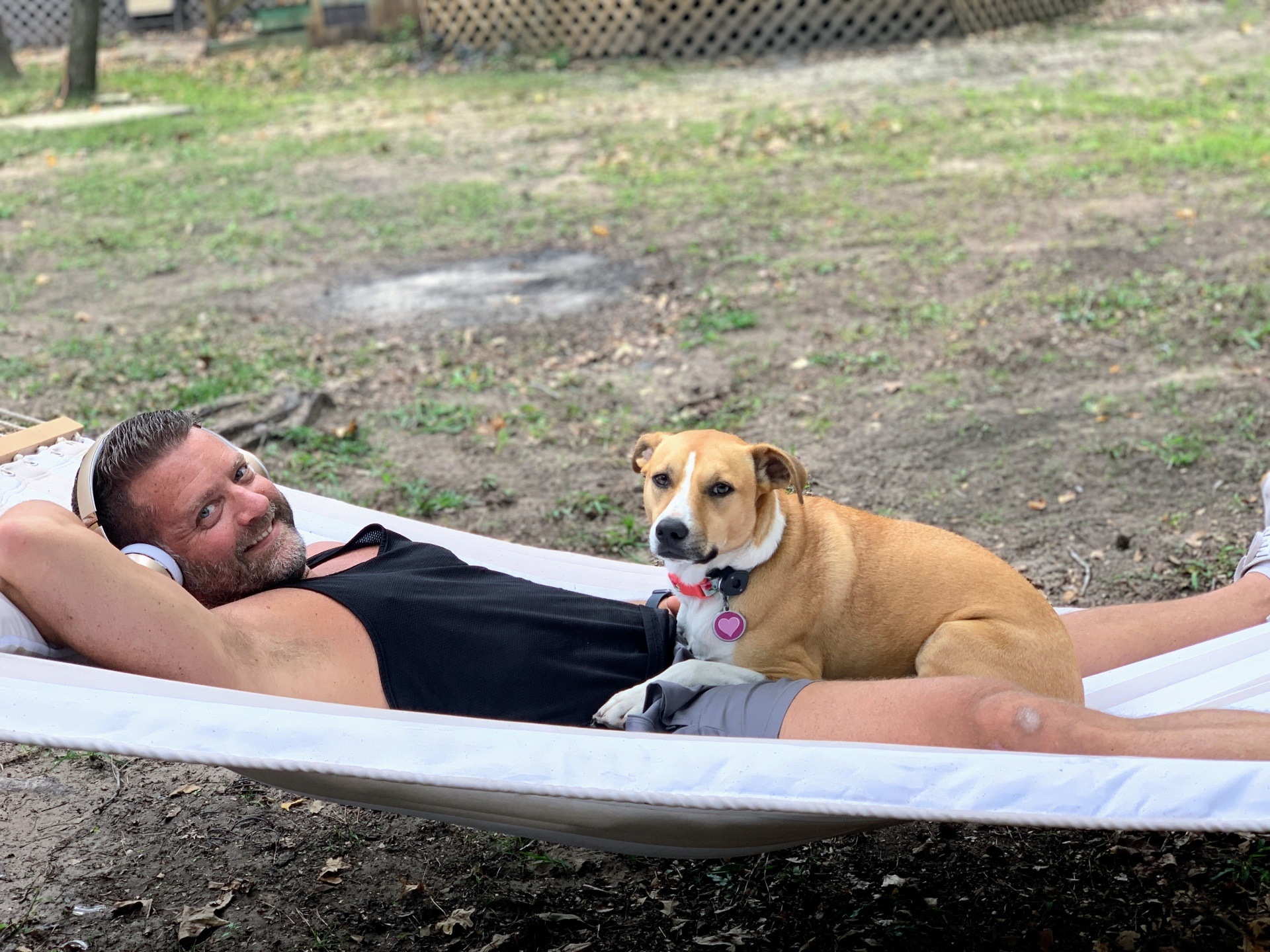 Dr. Pelton relaxing outdoors with his dog